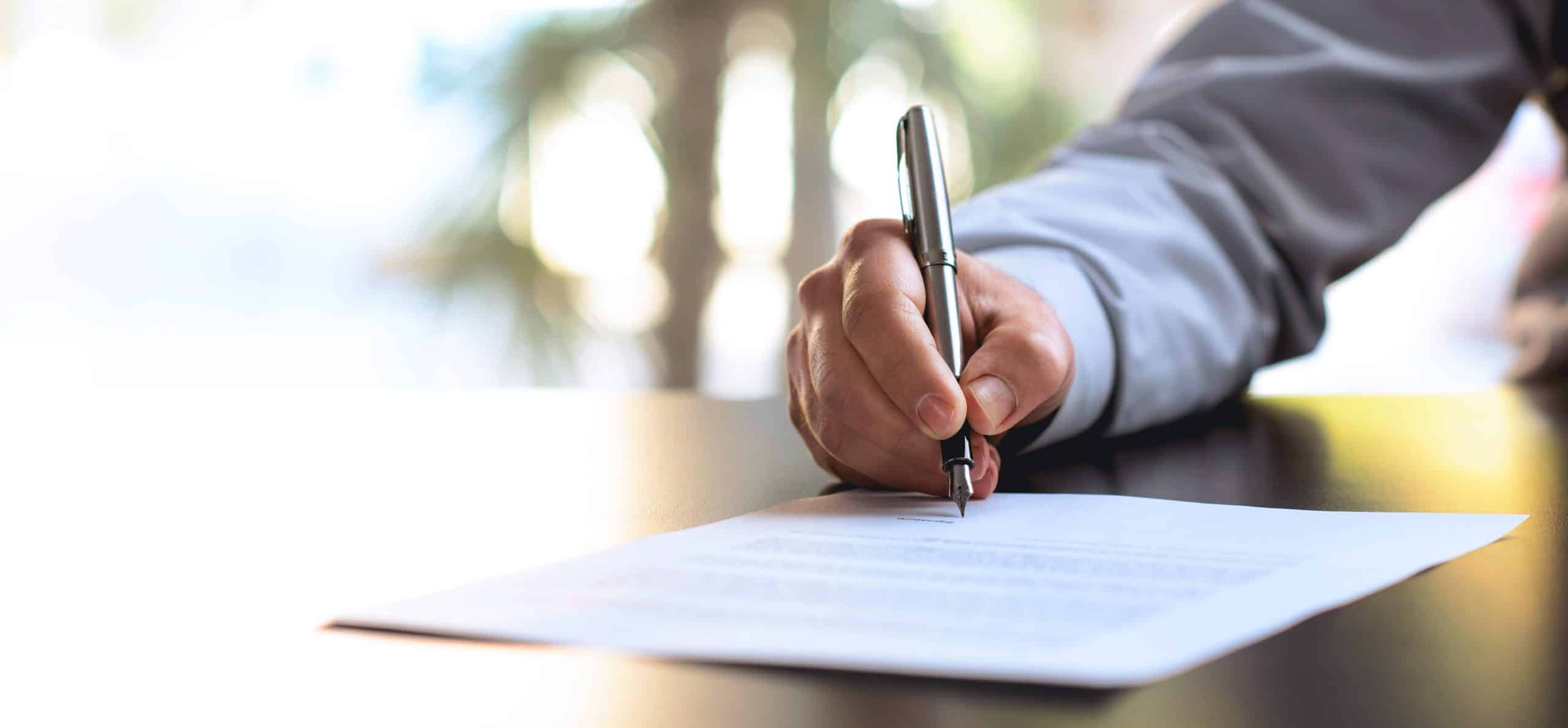 Businessman Signing An Official Document